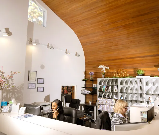 Receptionist desk with people on the phone